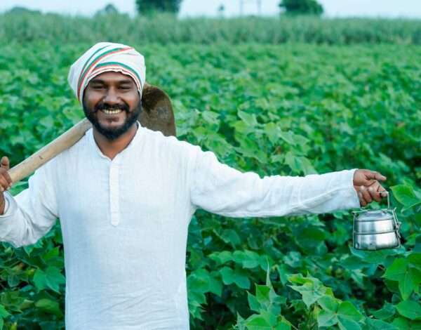 A Happy Farmer Standing In His Field.